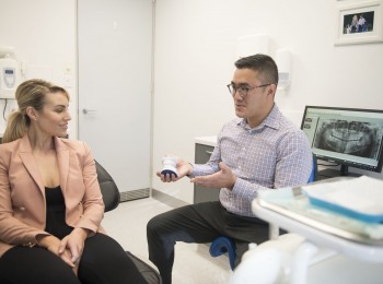 Dr Jasper Lee, discussing with a patient about their oral health