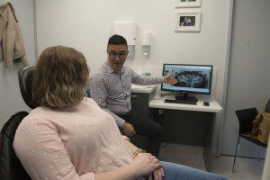 Dr jasper lee, associate dentist discussing a patient's opg jaw x-ray