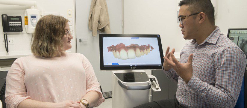 Dr Jasper Lee, associate dentist discussing the use of digital dentistry with a patient