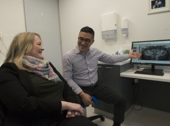 Dr Jasper Lee, associate dentist explaining an OPG jaw x-ray to a patient